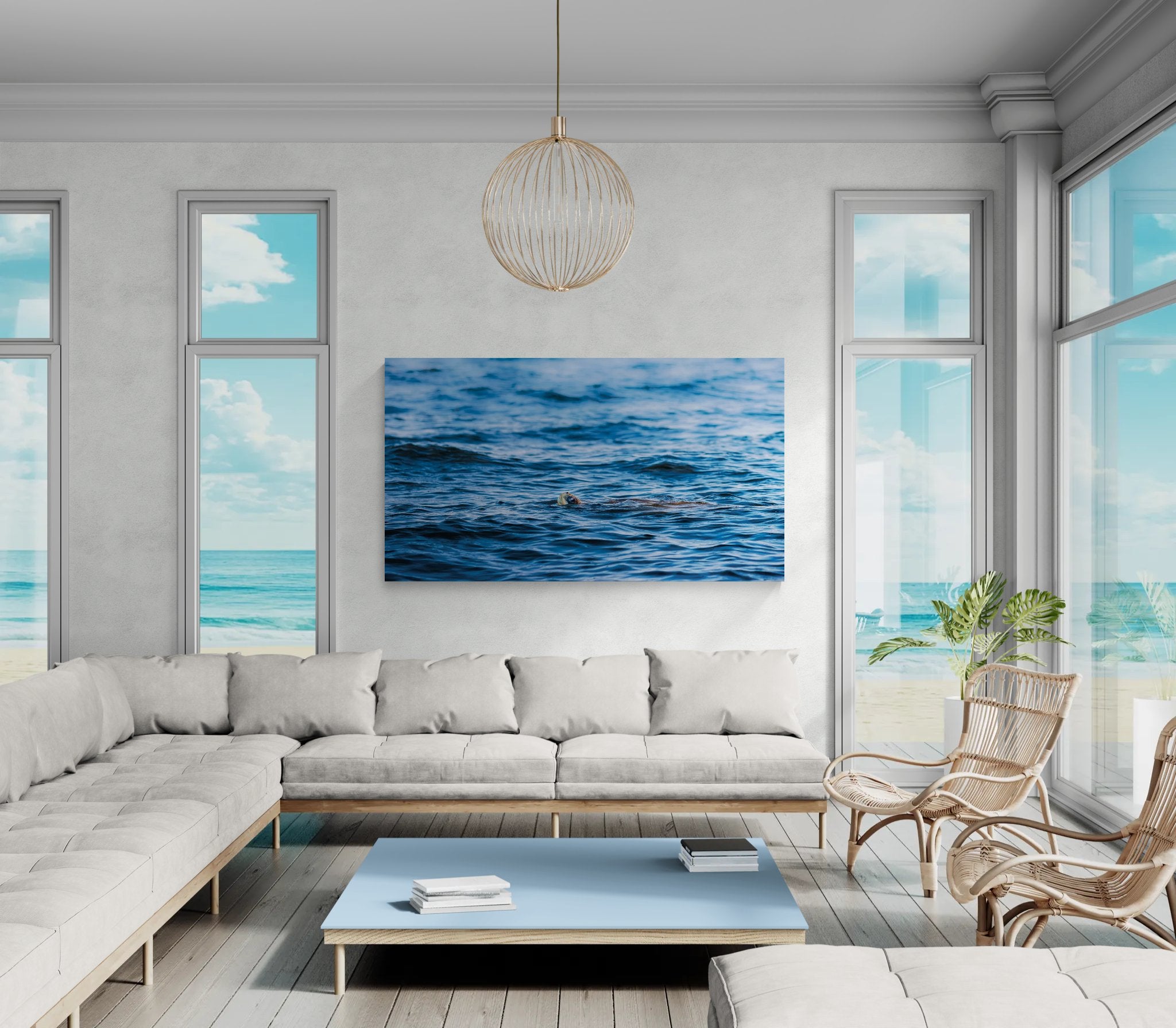 Modern living room with a large sectional sofa, coffee table, and wall art of a blue ocean scene.
