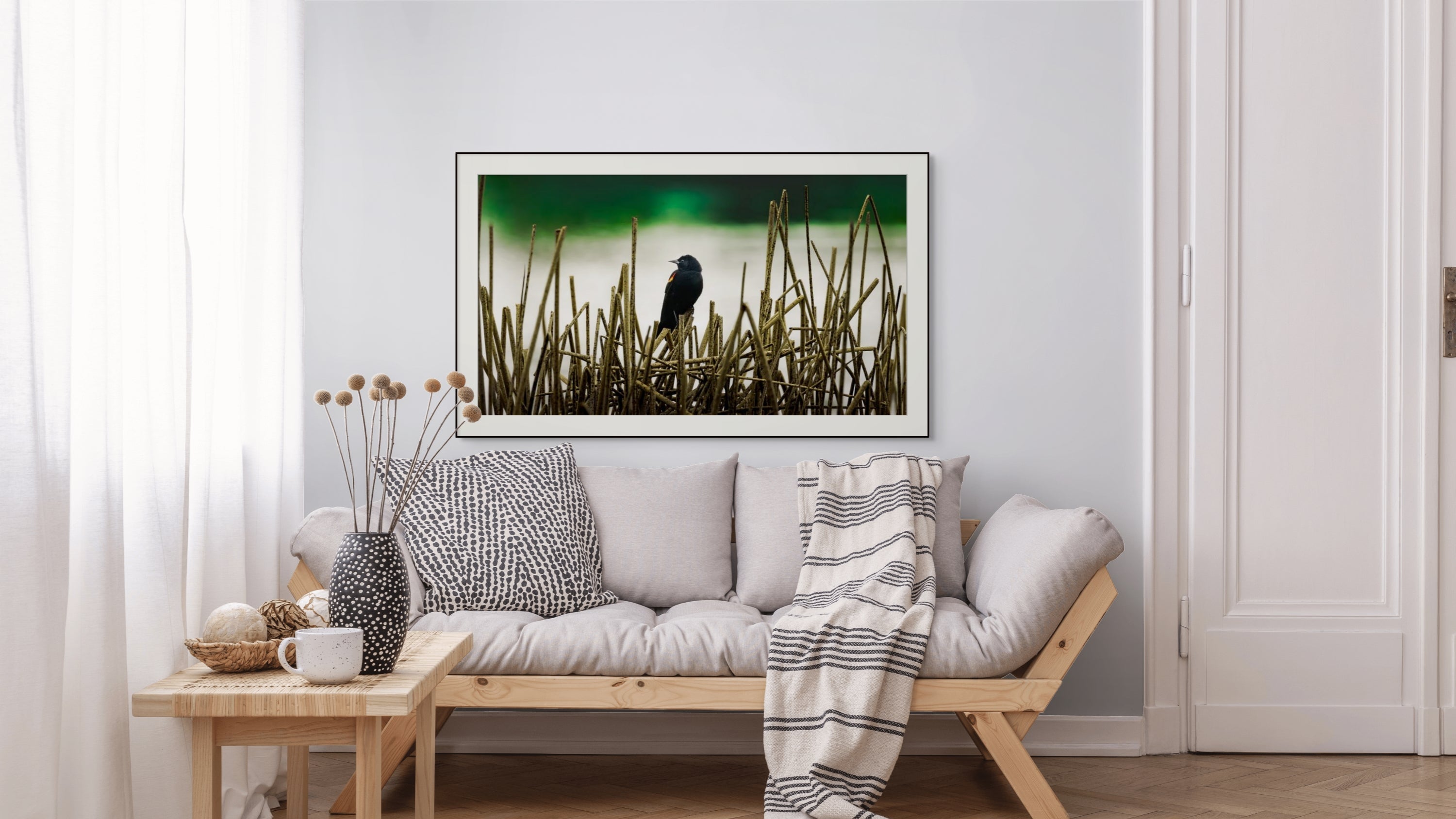 elegant room with blackbird fine art above sofa.