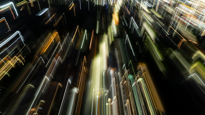 Aerial view of lights breaking across a decending city