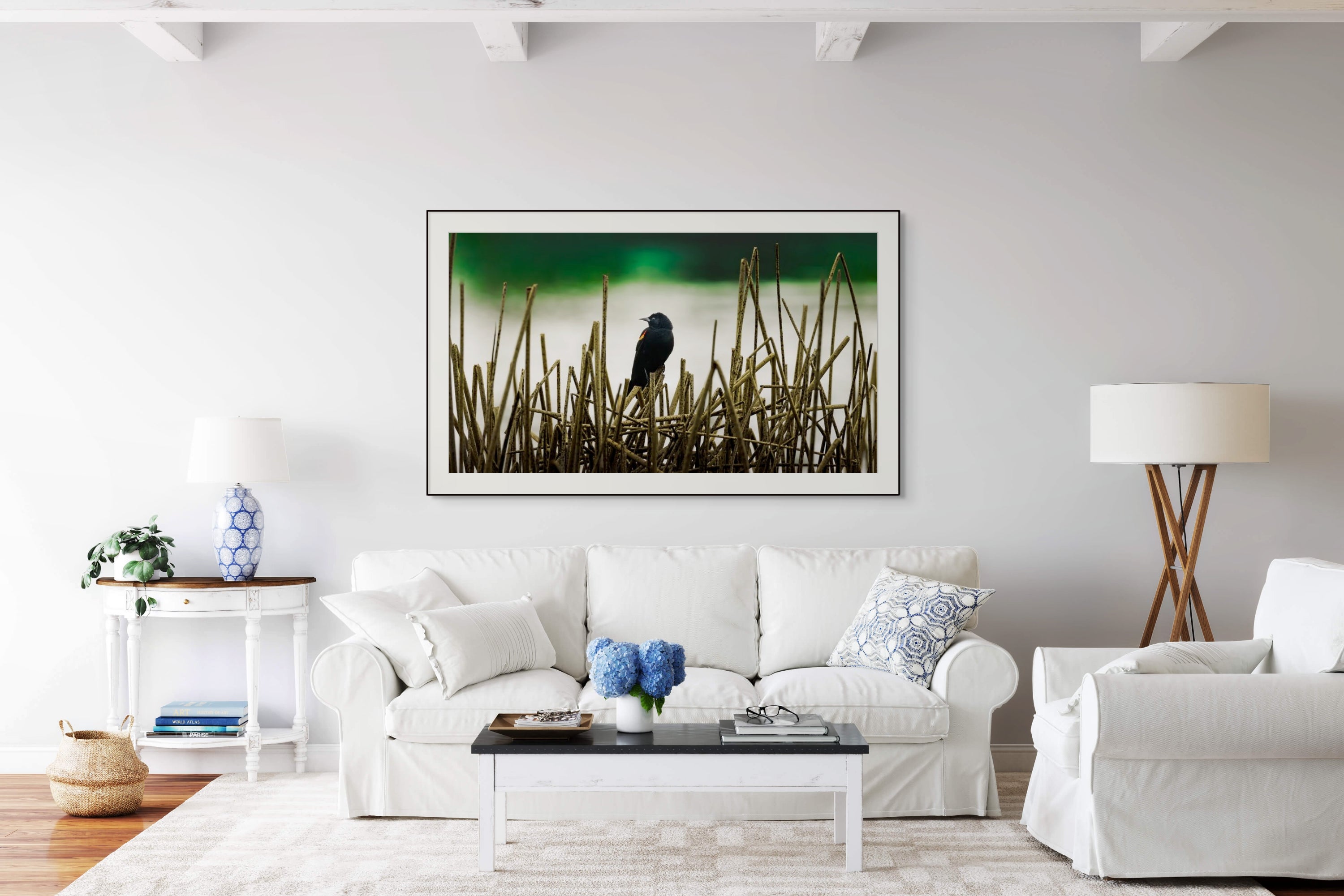 Blackbird fine art print above white sofa.