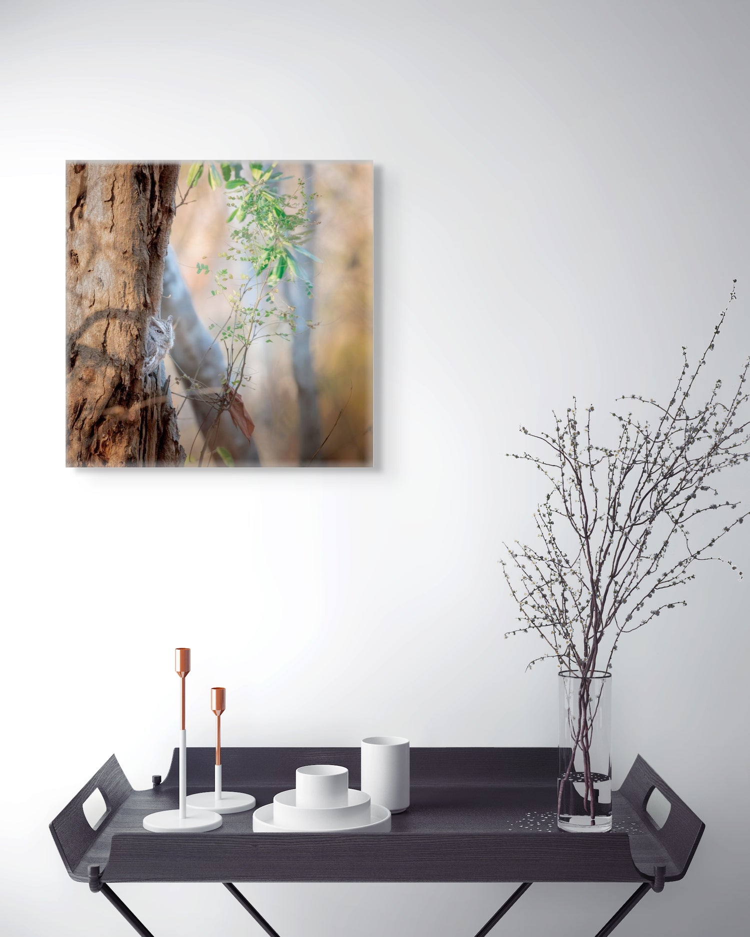 owl canvas print on the wall above console tray with decor.