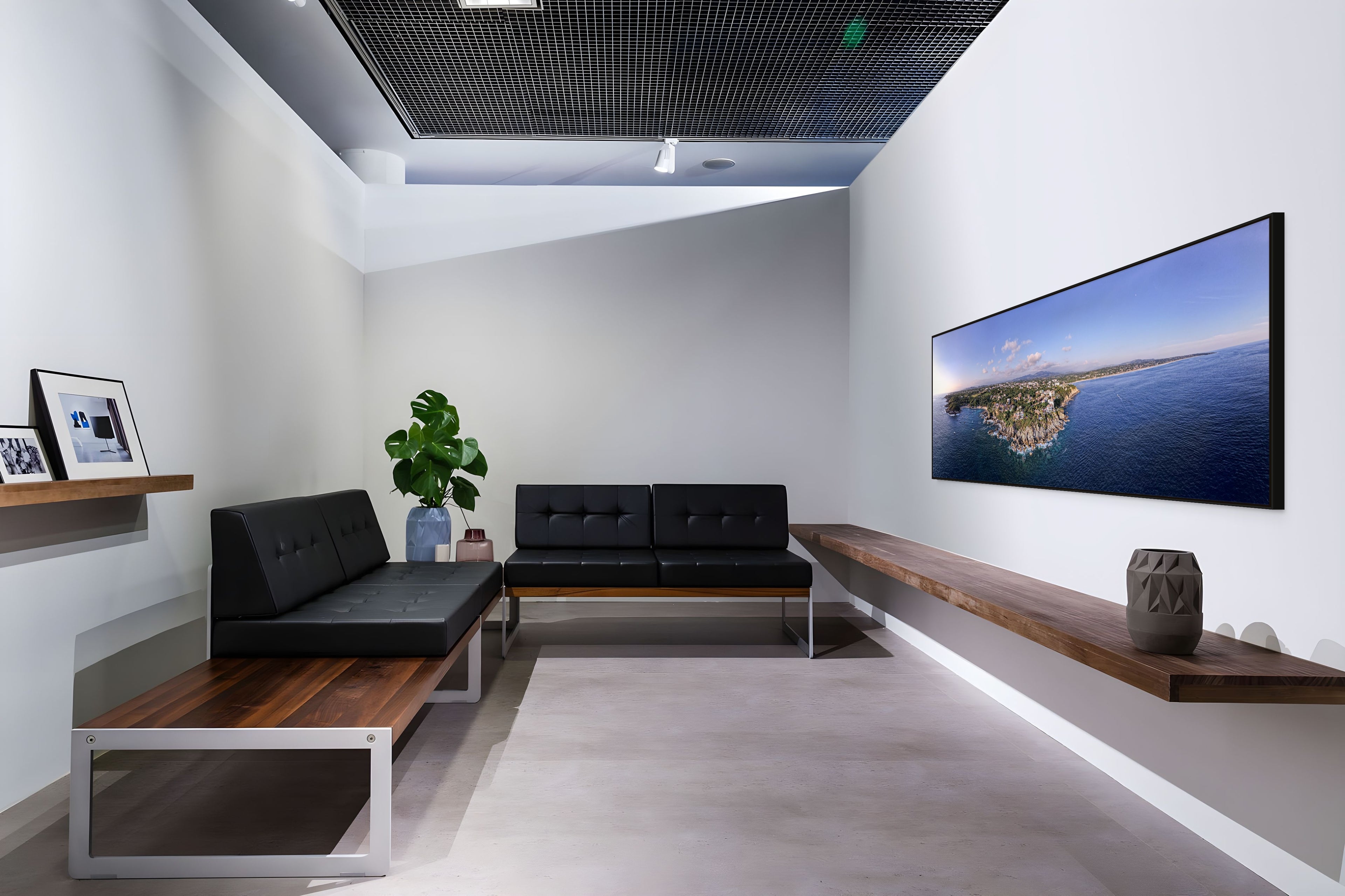 Modern living room with black sofa, wooden coffee table, and LARGE ARTWORK ARTBOX FRAME ON THE WALL.